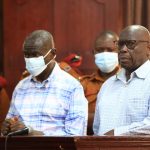 Veteran opposition politician Dr Kizza Besigye and his aide Hajj Obeid Lutale in the dock at the High court for the hearing of their bail application on March 14